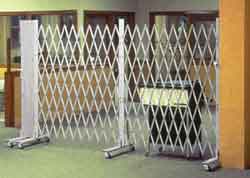 The classic folding gate design is that of an interlocking lattice of steel, riveted back to back to provide a sturdy barrier against intrusion and to withstand exposure to environmental elements.  
